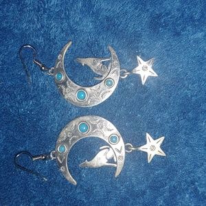 Silver wolf on moon with hanging star